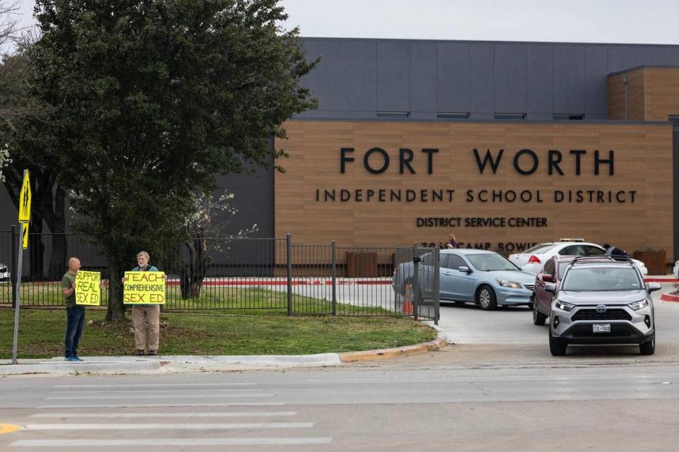 Gery Weichman, left, and former Texas state representative Lon Burnam holds signs in support of comprehensive sexual education in the Fort Worth Independent School District prior to a school board meeting at the Fort Worth ISD Administration Building on Tuesday, Feb. 27, 2024.