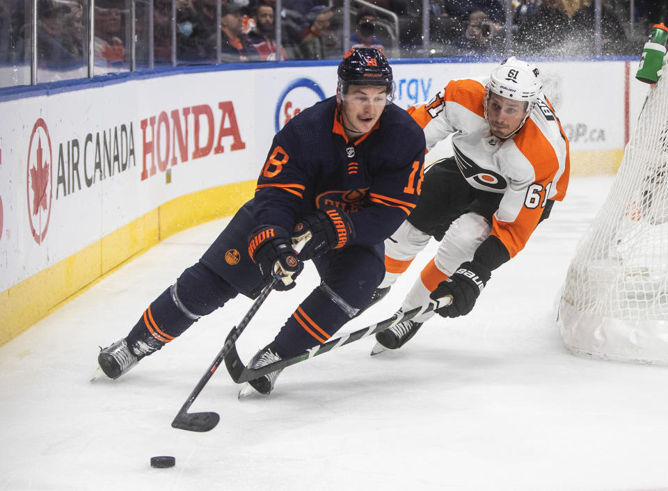 Philadelphia Flyers' Justin Braun (61) chases Edmonton Oilers' Zach Hyman (18) during the second period of an NHL hockey game, Wednesday, Oct. 27, 2021 in Edmonton, Alberta. (Jason Franson/The Canadian Press via AP)