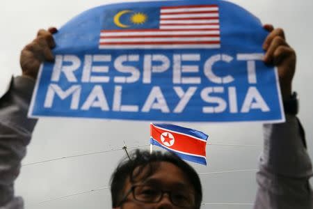 A member of the youth wing of the National Front, Malaysia's ruling coalition, holds a placard during a protest at the North Korea embassy, following the murder of Kim Jong Nam, in Kuala Lumpur, Malaysia, February 23, 2017. REUTERS/Athit Perawongmetha TPX IMAGES OF THE DAY