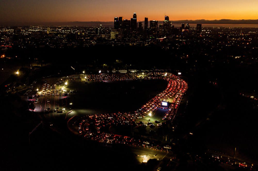 In this Nov 18, 2020, file aerial photo, motorists wait in long lines to take a coronavirus test in a parking lot at Dodger Stadium in Los Angeles. (AP Photo/Ringo H.W. Chiu, File)