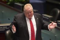 Toronto City Mayor Rob Ford attends a council meeting as councillors look to pass motions to limit his powers in Toronto on Monday.