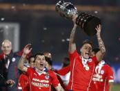 Chile's Gary Medel (L) and Chile's Eduardo Vargas celebrate with the trophy after defeating Argentina to win the Copa America 2015 final soccer match at the National Stadium in Santiago, Chile, July 4, 2015. REUTERS/Marcos Brindicci