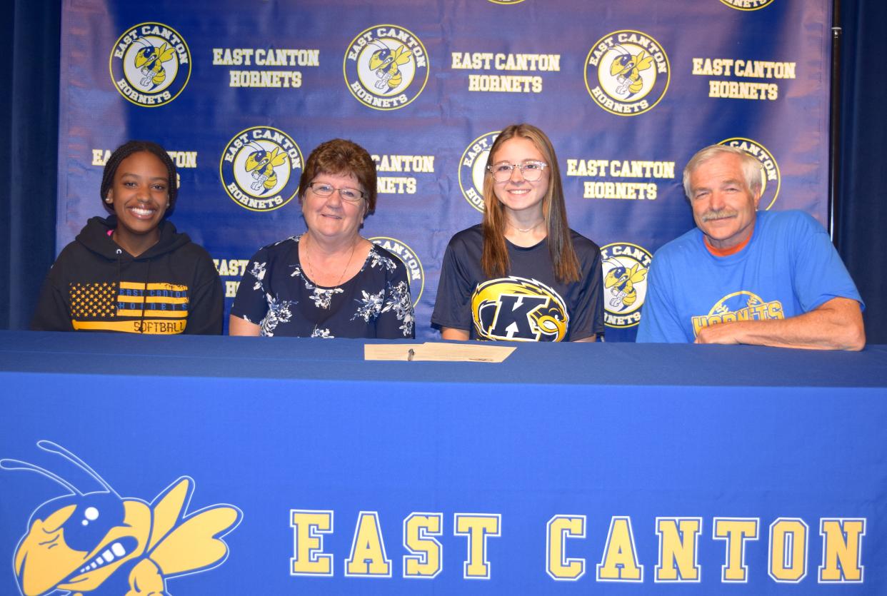 Signing a Letter of Intent is Madisyn Miller (third from left) sitting between her sister Jenna, her mother Marylou and her father Kevin.