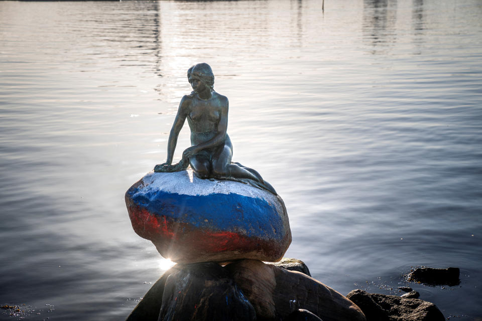 The Little Mermaid sculpture is seen vandalized with colours of the Russian flag painted on the stone she sits on, in Langelinie, Copenhagen, Denmark March 2, 2023. Ritzau Scanpix/Ida Marie Odgaard via REUTERS    ATTENTION EDITORS - THIS IMAGE WAS PROVIDED BY A THIRD PARTY. DENMARK OUT. NO COMMERCIAL OR EDITORIAL SALES IN DENMARK.