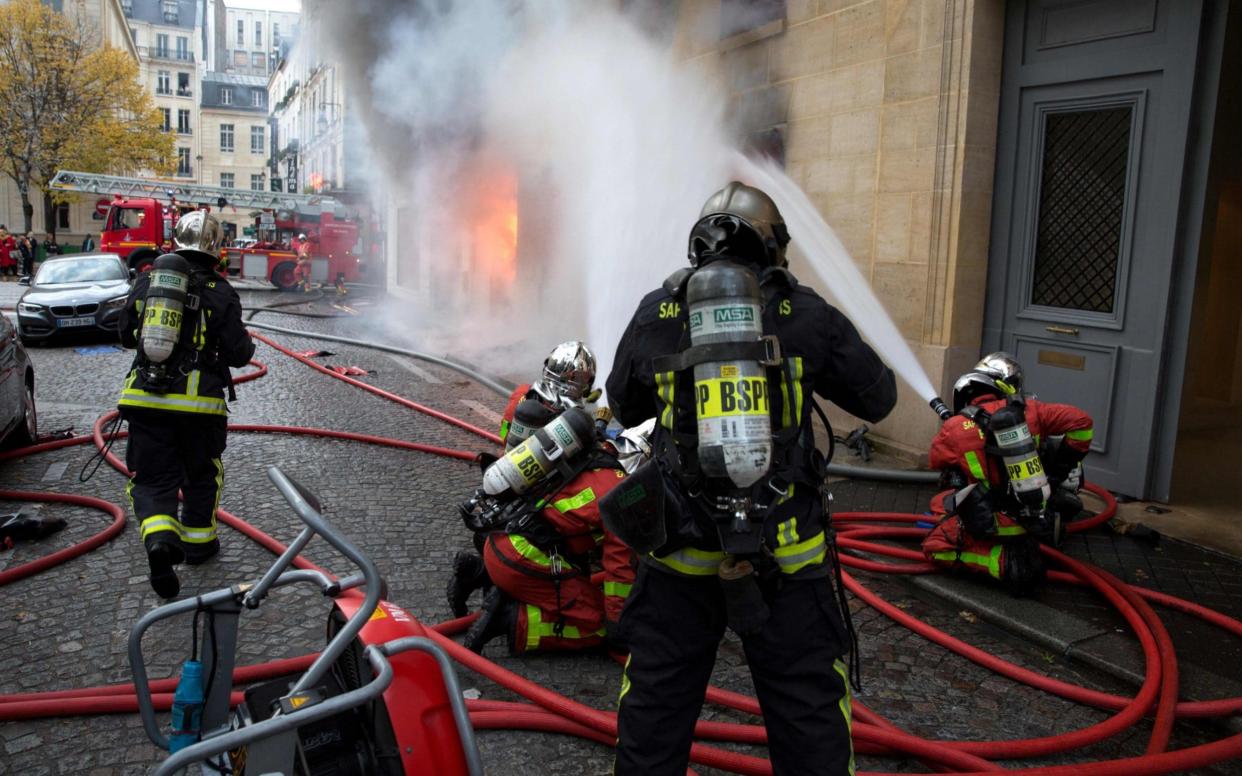 Firefighters work to put out a fire in