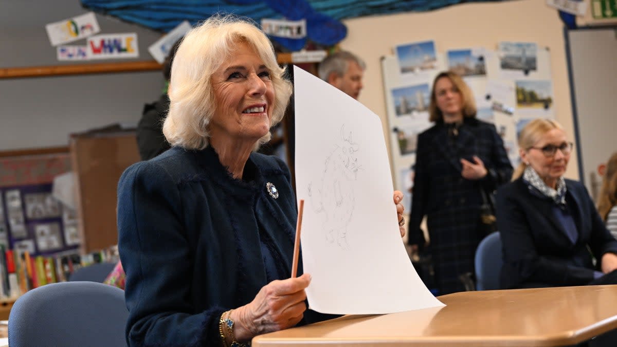 Camilla, Queen Consort draws a pictures of The Gruffalo with the children during a visit to Rudolf Ross Grundschule School (Getty Images)