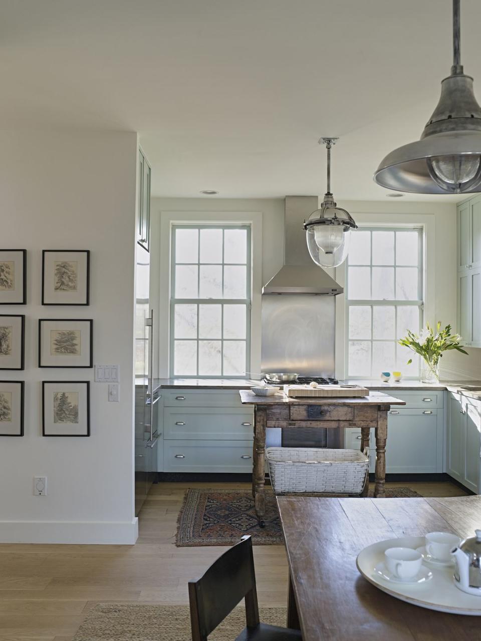 <p>“We wanted the kitchen cabinetry to be a fresh color, in contrast with the aged patina of the antique Swedish worktable,” says Heide Hendricks, principal interior designer at <a href="http://hendrickschurchill.com/" rel="nofollow noopener" target="_blank" data-ylk="slk:Hendricks Churchill;elm:context_link;itc:0;sec:content-canvas" class="link ">Hendricks Churchill</a>. “Knowing we didn’t want to obstruct the view out the windows, we decided to carry the same color onto the sash as a decorative layer in lieu of shades. The blue-green color on the cabinets is Teresa’s Green, and we used Pointing on the walls; both are by Farrow & Ball.”</p>