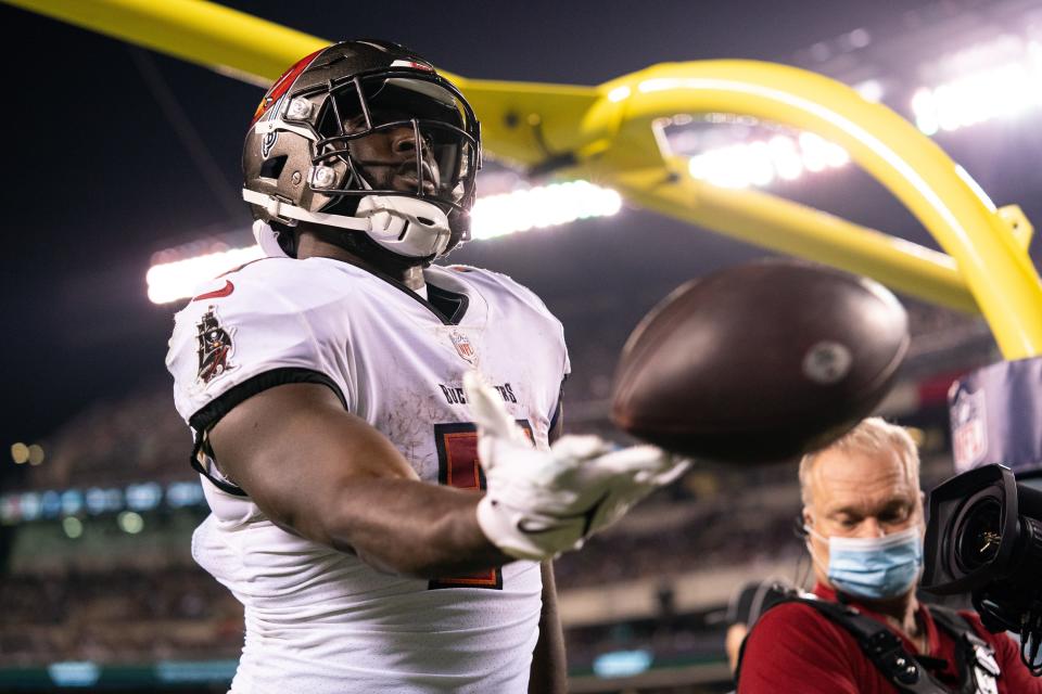 Tampa Bay Buccaneers running back Leonard Fournette tosses the ball into the stands after scoring a touchdown against the Philadelphia Eagles.