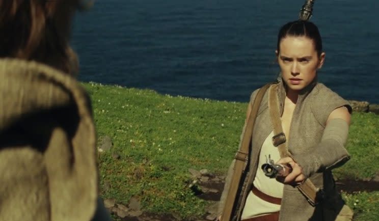 Rey returns the lightsaber to Luke - Credit: Lucasfilm