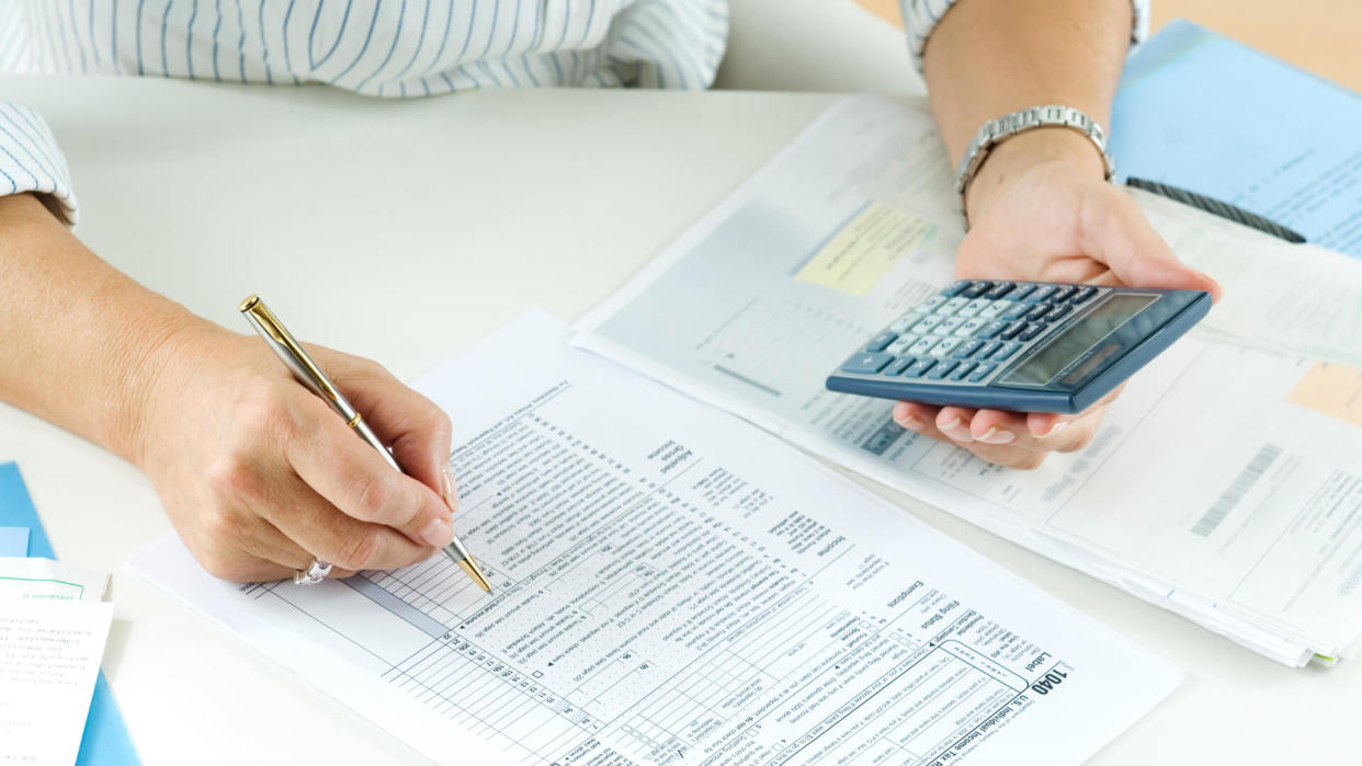 Woman calculating her taxes.