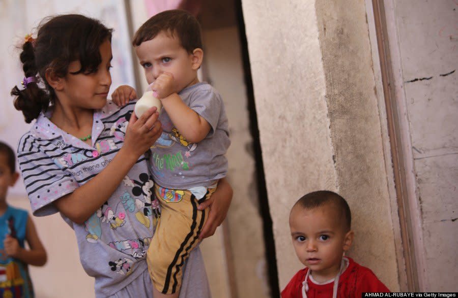 Iraqi Turkmen Shiite children displaced from the northern Iraqi area of Tal Afar take shelter in a school in Sadr City on August 5, 2014. (AHMAD AL-RUBAYE/AFP/Getty Images) 