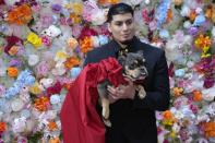A dog and model attend the Pet Gala fashion show at AKC Museum of The Dog on Monday, May 20, 2024, in New York. (Photo by Charles Sykes/Invision/AP)