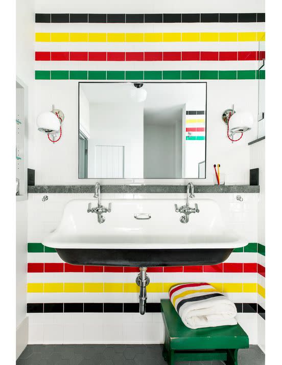 bathroom with green red yellow and back tile