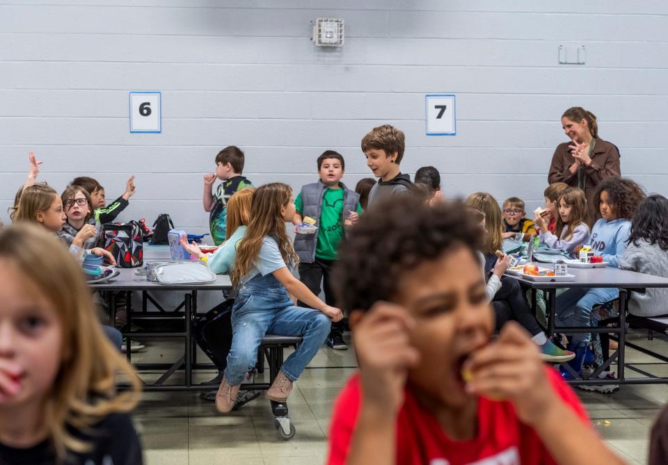 Students eat their food during a lunch period at Wilcox Elementary School in Holt on Wednesday, Nov. 8, 2023. Students at the school are supplied with free lunches as part of the Michigan School Meals project, which makes breakfast and lunch free for all students in public schools.