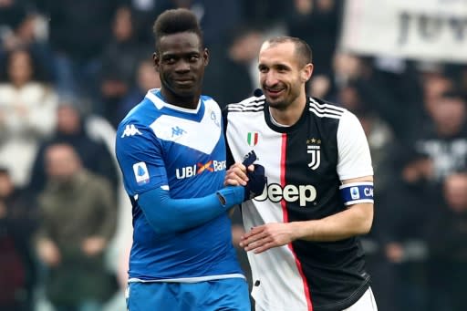 Brescia's Mario Balotelli greets Juventus captain Giorgio Chiellini who returned after a six-month injury layoff