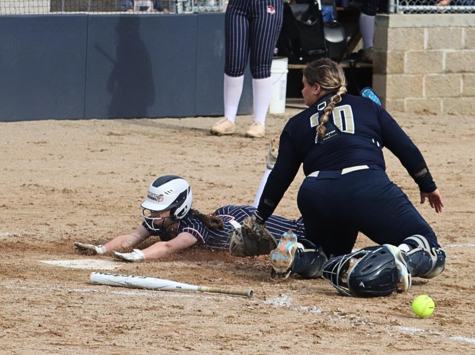 Pontiac's Tessa Collins slides safely into home for a run against Central Catholic. PTHS won the Illini Prairie Conference game 7-1.