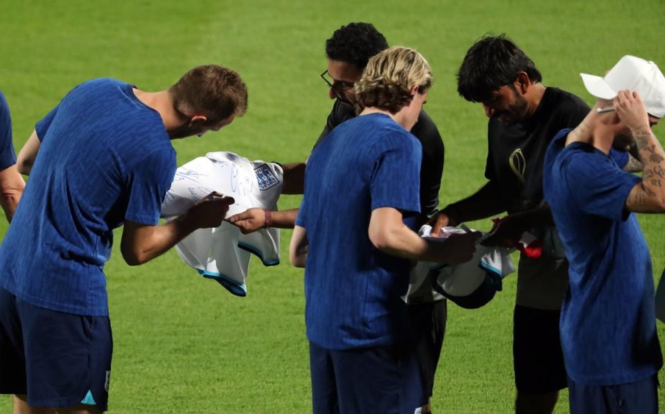 The team, including captain Harry Kane, signed shirts (EPA)