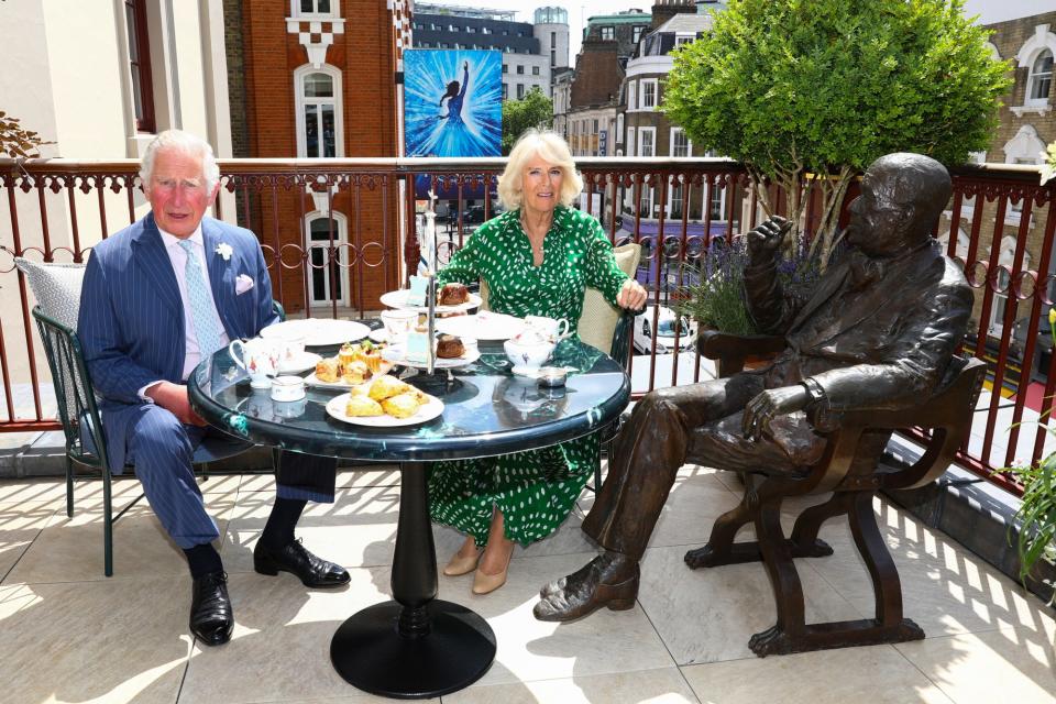 <p>Prince Charles and Camilla, Duchess of Cornwall enjoy afternoon tea beside a statue of playwright Nöel Coward during a visit to Theatre Royal on June 23 in London.</p>