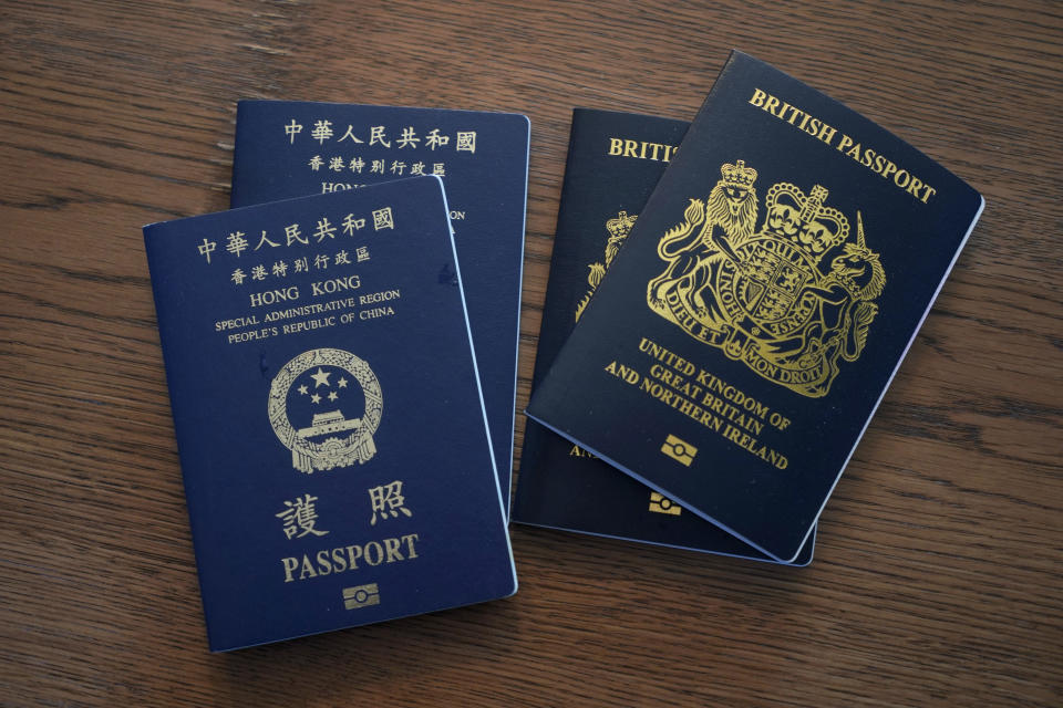 British National Overseas passports (BNO) and Hong Kong Special Administrative Region of the People's Republic of China passports are displayed by Mike Hui at home in Hong Kong on Jan. 31, 2021. Until early April, Hui was a photojournalist for the Apple Daily, a pro-democracy newspaper that shut down following the arrest of five top editors and executives and the freezing of its assets under a national security law that China's ruling Communist Party imposed on Hong Kong as part of the crackdown. (AP Photo/Kin Cheung)