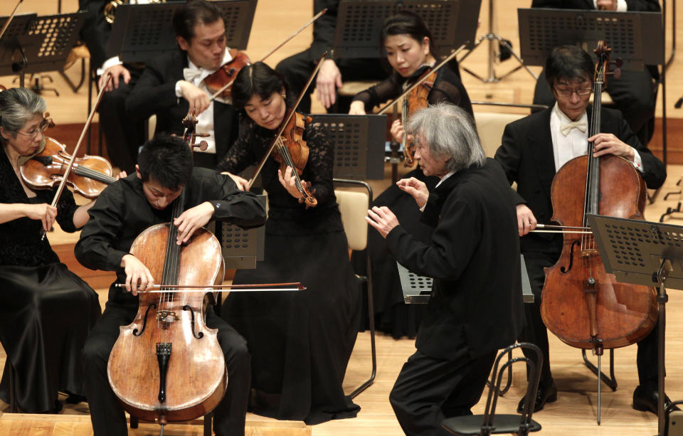 FILE - Seiji Ozawa, front right, conducts violoncellist Dai Miyata, left in front, with the Mito Chamber Orchestra at Suntory Hall in Tokyo, Sunday, Jan. 22, 2012. World-renowned conductor Ozawa has died of heart failure at his home in Tokyo, his management office said Friday, Feb. 9, 2024. He was 88. (AP Photo/Shizuo Kambayashi, File)