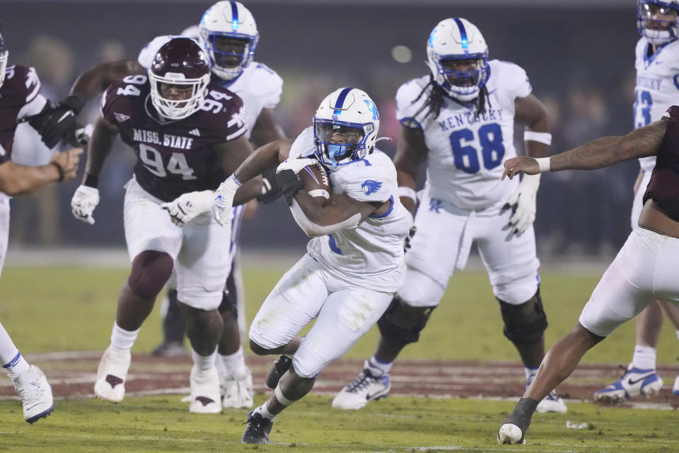 Kentucky running back Ray Davis (1) runs past his blockers and Mississippi State defensive tackle Jaden Crumedy (94) for a first down during the first half of an NCAA college football game in Starkville, Miss., Saturday, Nov. 4, 2023. (AP Photo/Rogelio V. Solis)