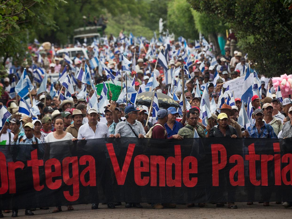 Opponents to the construction of Nicaragua's transoceanic canal take part in a national protest march against the canal project, in Juigalpa, Nicaragua. The banner reads: "Ortega traitor.": Esteban Felix/ AP