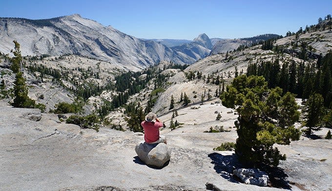 Using binoculars at Olmsted Point to watch hikers ascend Half Dome in Yosemite. Photo by Gloria Wadzinski