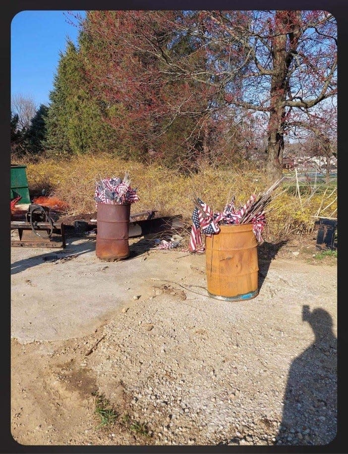 Discarded flags in burn barrels and on the ground at Cedar Hill Cemetery, according to cemetery critics.