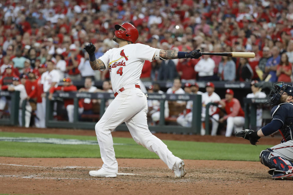 St. Louis Cardinals' Yadier Molina hits a sacrifice fly to score Kolten Wong for the winning run during the 10th inning in Game 4 of a baseball National League Division Series against the Atlanta Braves, Monday, Oct. 7, 2019, in St. Louis. (AP Photo, Charlie Riedel)