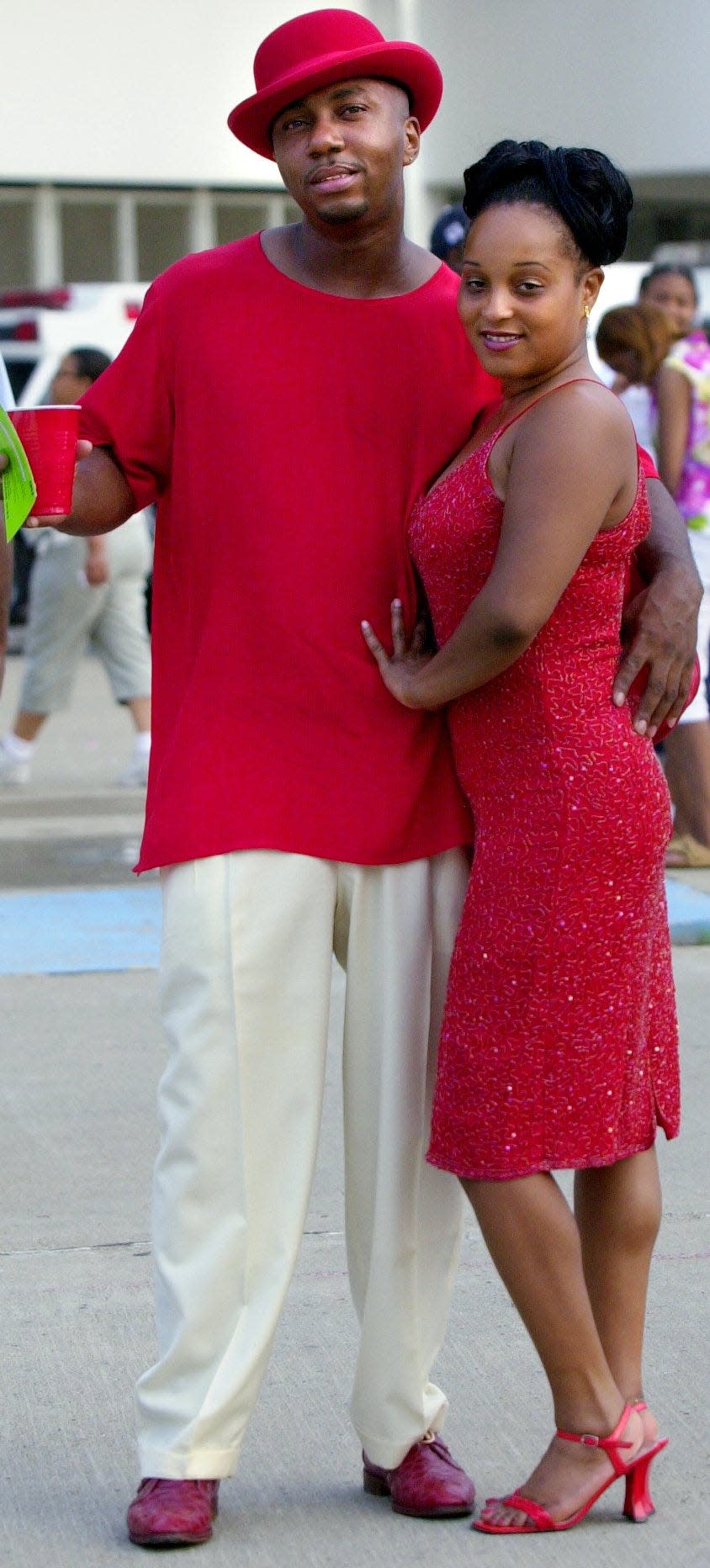 Orlando Junious of Bond Hill and Tracy Gibson of Colerain pose outside Cinergy Field on their way to the Coors Light Festival, July 20, 2001.