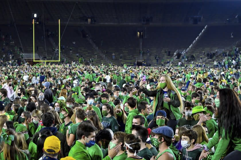 Fans storm the field after Notre Dame defeated the Clemson 47-40 in two overtimes in an NCAA.