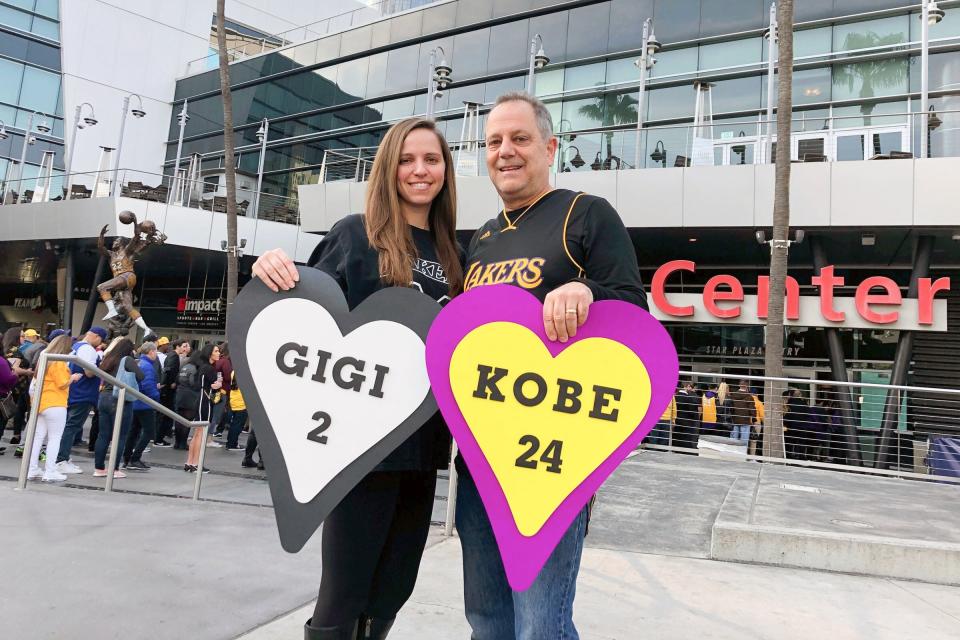 Alyssa Shapiro, 27, of Huntington Beach, and her father Rick Shapiro, 55, stood outside holding posters in honor of the late father and daughter.