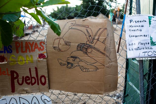 Signs of protest hang on the fence of the residential building. (Photo: Erika P. Rodriguez for HuffPost)