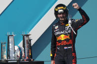 Red Bull driver Max Verstappen of the Netherlands takes the stage wearing a football helmet after winning the Formula One Miami Grand Prix auto race at the Miami International Autodrome, Sunday, May 8, 2022, in Miami Gardens, Fla. (AP Photo/Lynne Sladky)