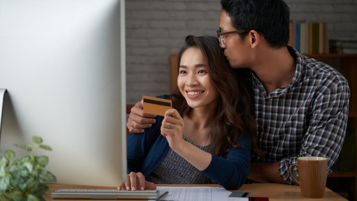 Young couple making online purchases at home.