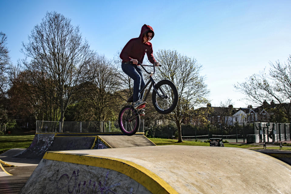 A boy on his BMX rides up a ramp as he gets his daily exercise in a skatepark while the UK continues in lockdown to help curb the spread of the coronavirus.