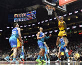 Atlanta Hawks forward John Collins tips in a basket during the first half of an NBA basketball game against the Charlotte Hornets, Sunday, Dec. 5, 2021, in Atlanta. (AP Photo/Edward M. Pio Roda)