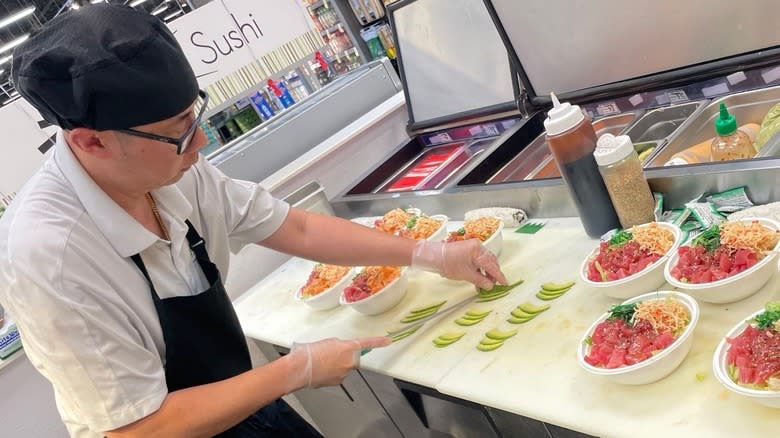 sushi chef making poke bowls
