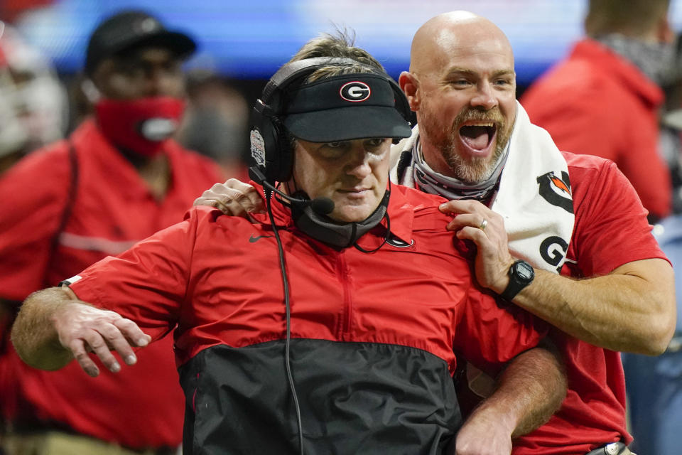 Georgia head coach Kirby Smart and another coach celebrate a Georgia field goal to beat Cincinnati during the second half of the Peach Bowl NCAA college football game, Friday, Jan. 1, 2021, in Atlanta. Georgia won 22-21. (AP Photo/Brynn Anderson)