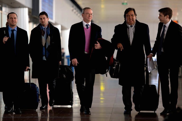 Former New Mexico governor Bill Richardson (2nd R) and Google chairman Eric Schmidt (C) arrive at Beijing airport from North Korea, on January 10, 2013. Richardson and Schmidt met with reporters following their visit to the secretive state calling for greater Internet freedom for the welfare of its people