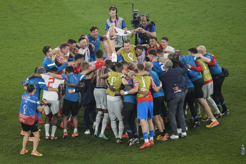 Switzerland's team celebrate after the end of the World Cup group G soccer match between Serbia and Switzerland, at the Stadium 974 in Doha, Qatar, Friday, Dec. 2, 2022. Switzerland' won 3-2 .(AP Photo/Luca Bruno)