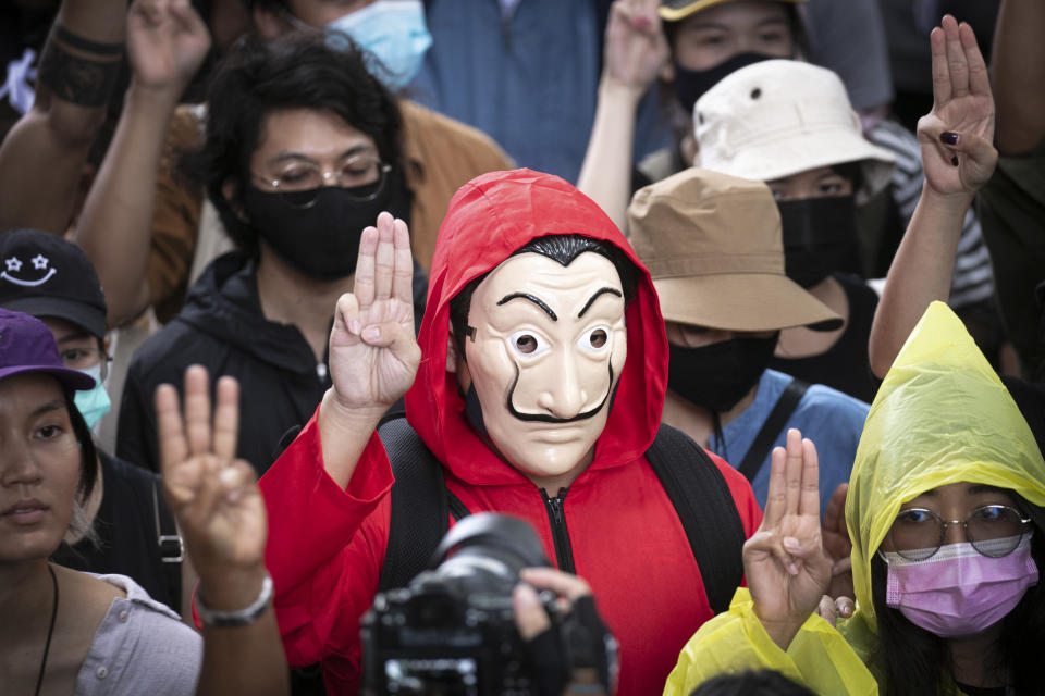 Pro-democracy protesters raise a three-finger symbol of resistance during a protest at the Sanam Luang field during a protest in Bangkok, Thailand, Saturday, Sept. 19, 2020. Protesters gathered Saturday in Bangkok for what was expected to be the biggest rally yet in an ongoing campaign calling for a new election and democratic reforms. (AP Photo/Wason Wanichakorn)