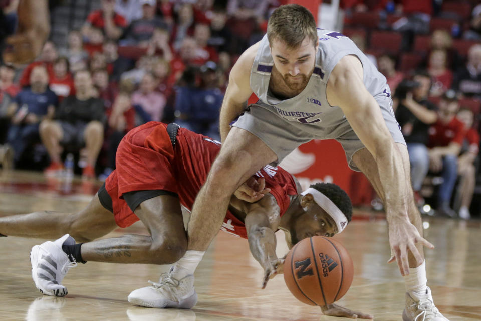 Northwestern's Ryan Young (15) and Nebraska's Dachon Burke Jr., rear, go for a loose ball during overtime in an NCAA college basketball game in Lincoln, Neb., Sunday, March 1, 2020. Northwestern won 81-76. (AP Photo/Nati Harnik)
