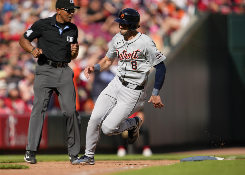 Detroit Tigers' Matt Vierling (8) rounds third base and scores on a double hit by teammate Mark Canha in the eighth inning of a baseball game against the Cincinnati Reds in Cincinnati, Saturday, July 6, 2024. (AP Photo/Jeff Dean)