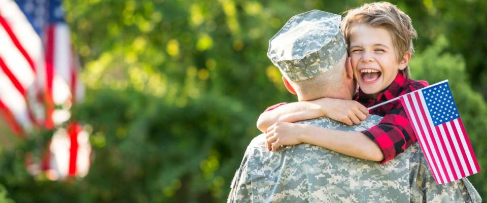 Happy reunion of soldier with family, son hug father