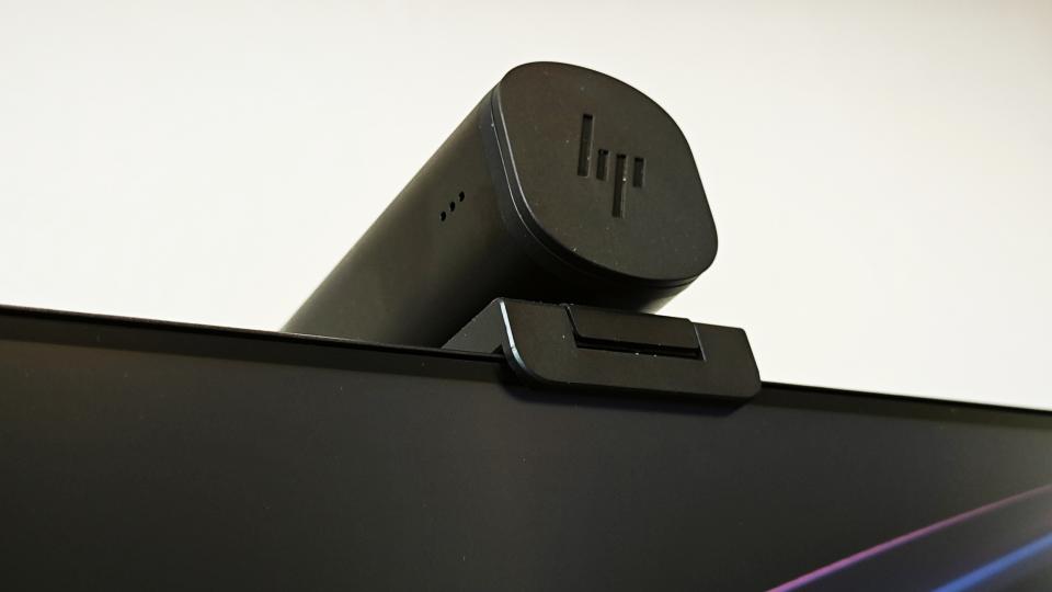 A black HP 965 4K webcam perched on a monitor