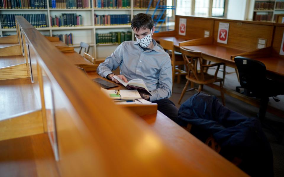 A student wears a face mask in a library - Christopher Furlong/Getty Images