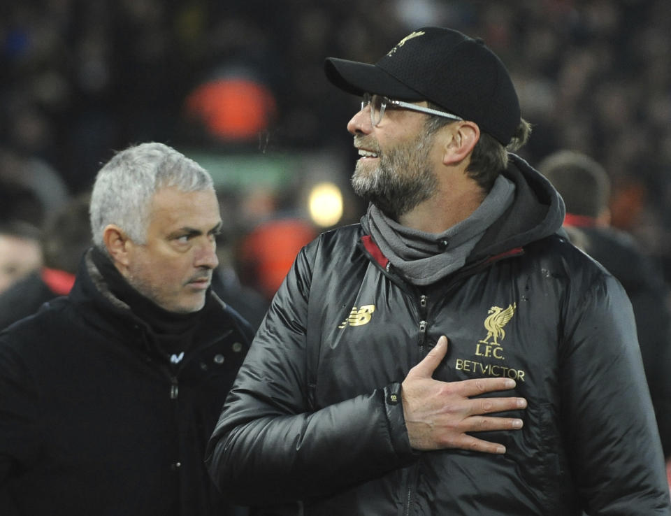 Liverpool manager Juergen Klopp, right, and Manchester United manager Jose Mourinho seen prior to the English Premier League soccer match between Liverpool and Manchester United at Anfield in Liverpool, England, Sunday, Dec. 16, 2018. (AP Photo/Rui Vieira)