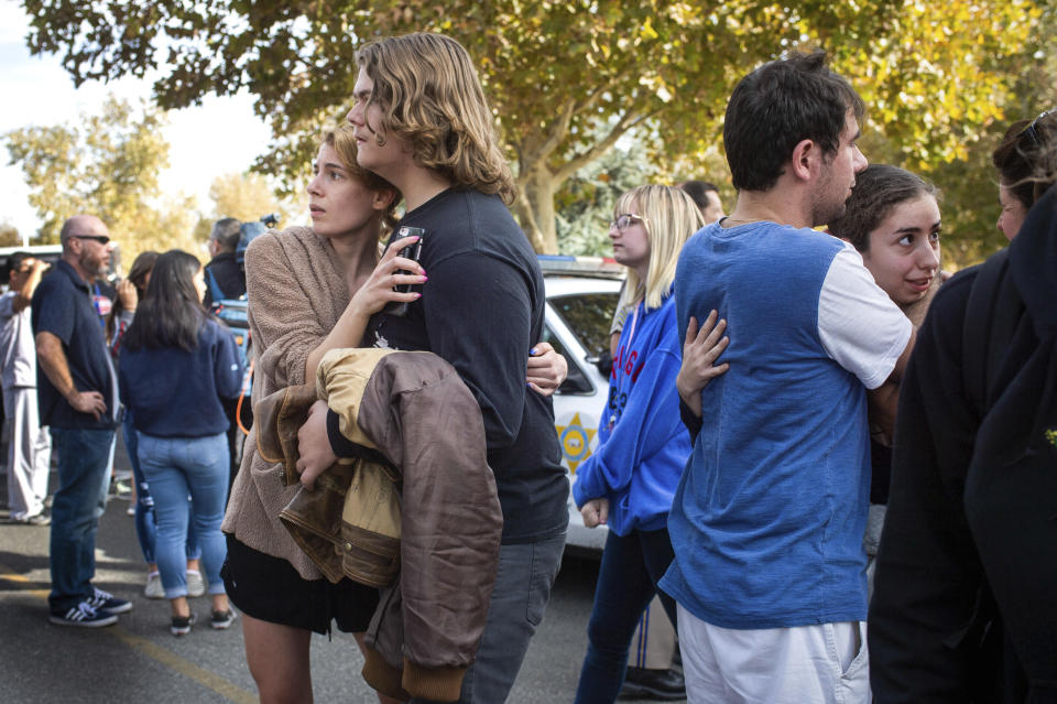 Saugus High School students reunite with their families in Central Park following a shooting that injured several people at Saugus High School, Thursday, Nov. 14, 2019, in Santa Clarita, Calif. (Sarah Reingewirtz/The Orange County Register via AP)