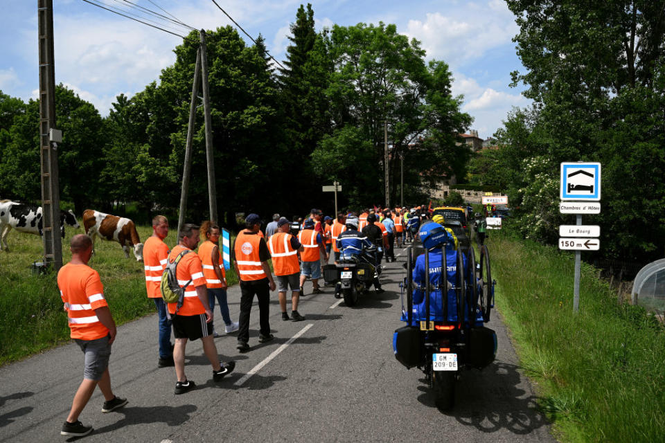 LE COTEAU FRANCE  JUNE 06 Protesters block the road in Marols village during the 75th Criterium du Dauphine 2023 Stage 3 a 1941km stage from MonistrolsurLoire to Le Coteau  UCIWT  on June 06 2023 in Le Coteau France Photo by Dario BelingheriGetty Images
